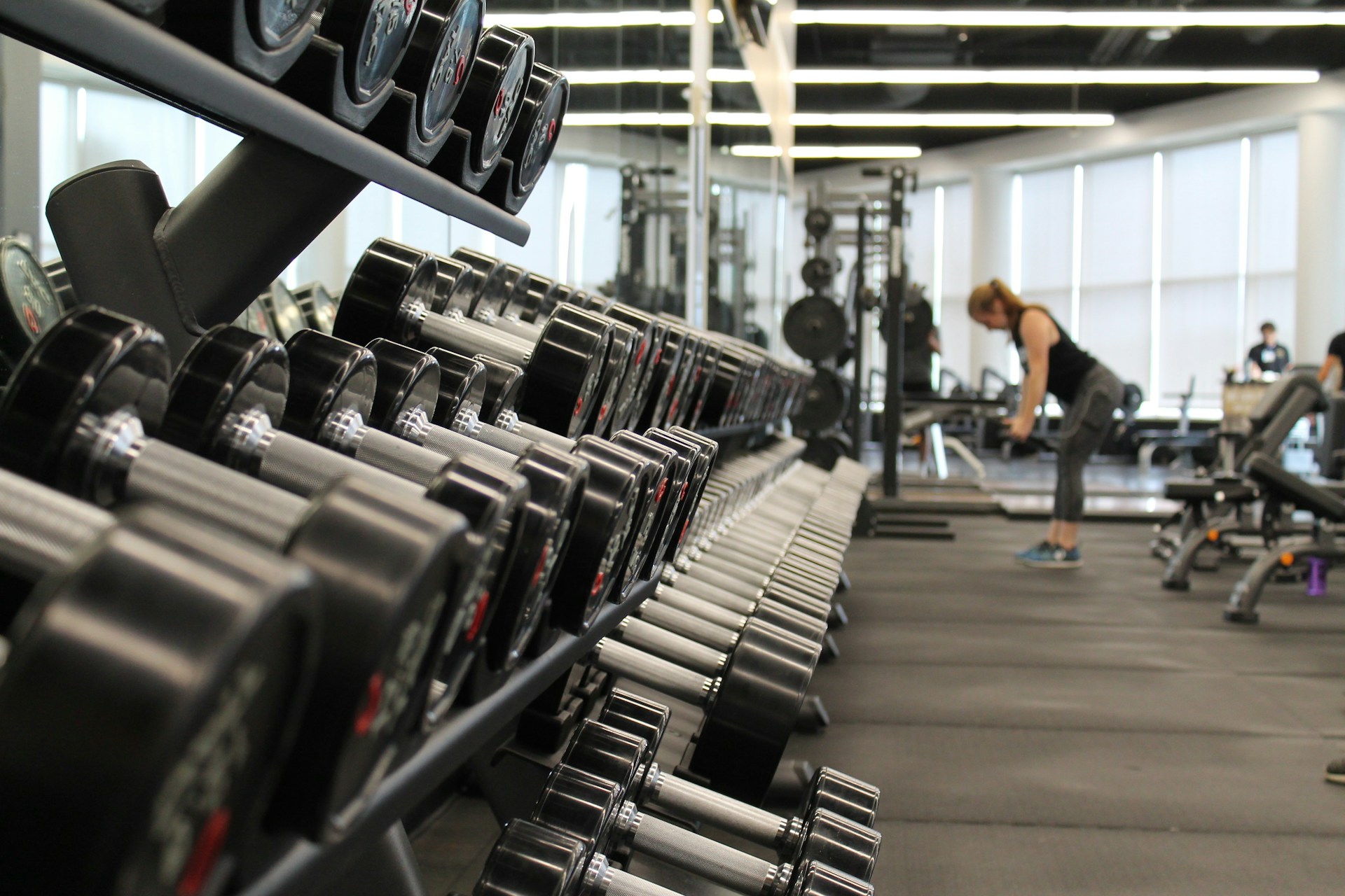 Dumbbell rack in a modern gym — strength training lifestyle imagery for testosterone replacement therapy